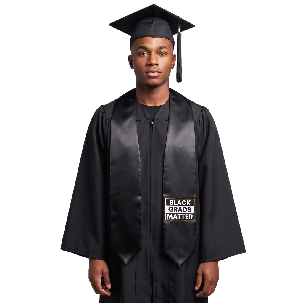 Black graduation stole with “BLACK GRADS MATTER” lettering in a black and white rectangular design outlined in gold on one side and pointed ends.
