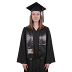 Graduate in a black cap and gown wearing a black First Gen Proud graduation stole with white lettering, a gold graduation cap design, and a gold rectangular border on one side.
