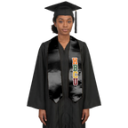 Graduate in a black cap and gown wearing a black HBCU graduation stole with vertically stacked multicolored HBCU lettering outlined in white on one side and pointed ends.
