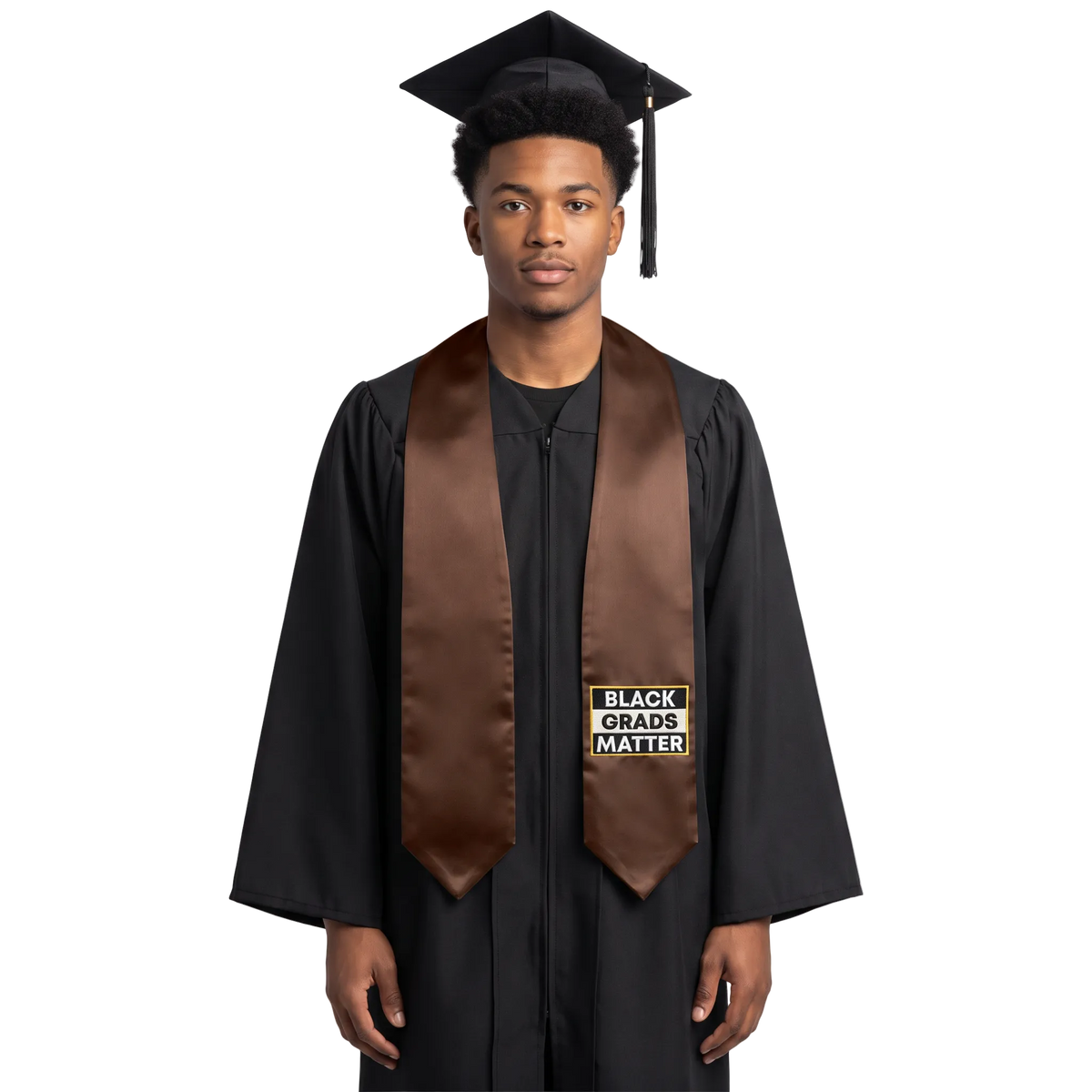 Brown graduation stole with “BLACK GRADS MATTER” lettering in a black and white rectangular design outlined in gold on one side and pointed ends.
