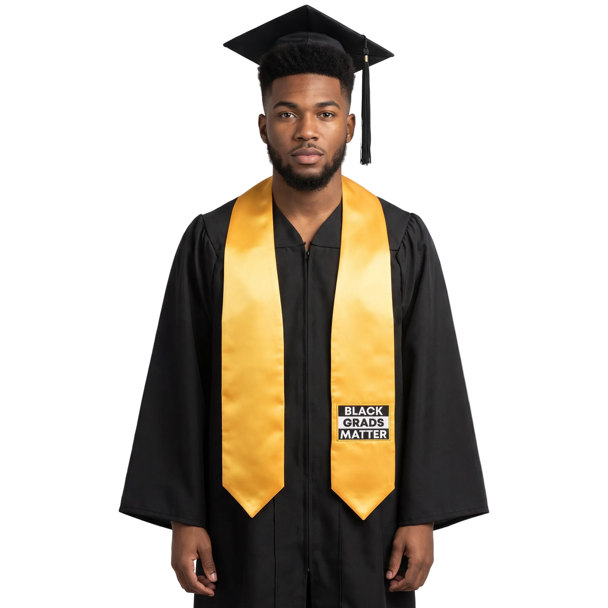 Gold graduation stole with “BLACK GRADS MATTER” lettering in a black and white rectangular design outlined in gold on one side and pointed ends.
