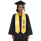 Graduate in a black cap and gown wearing a gold HBCU graduation stole with vertically stacked multicolored HBCU lettering on one side and pointed ends.
