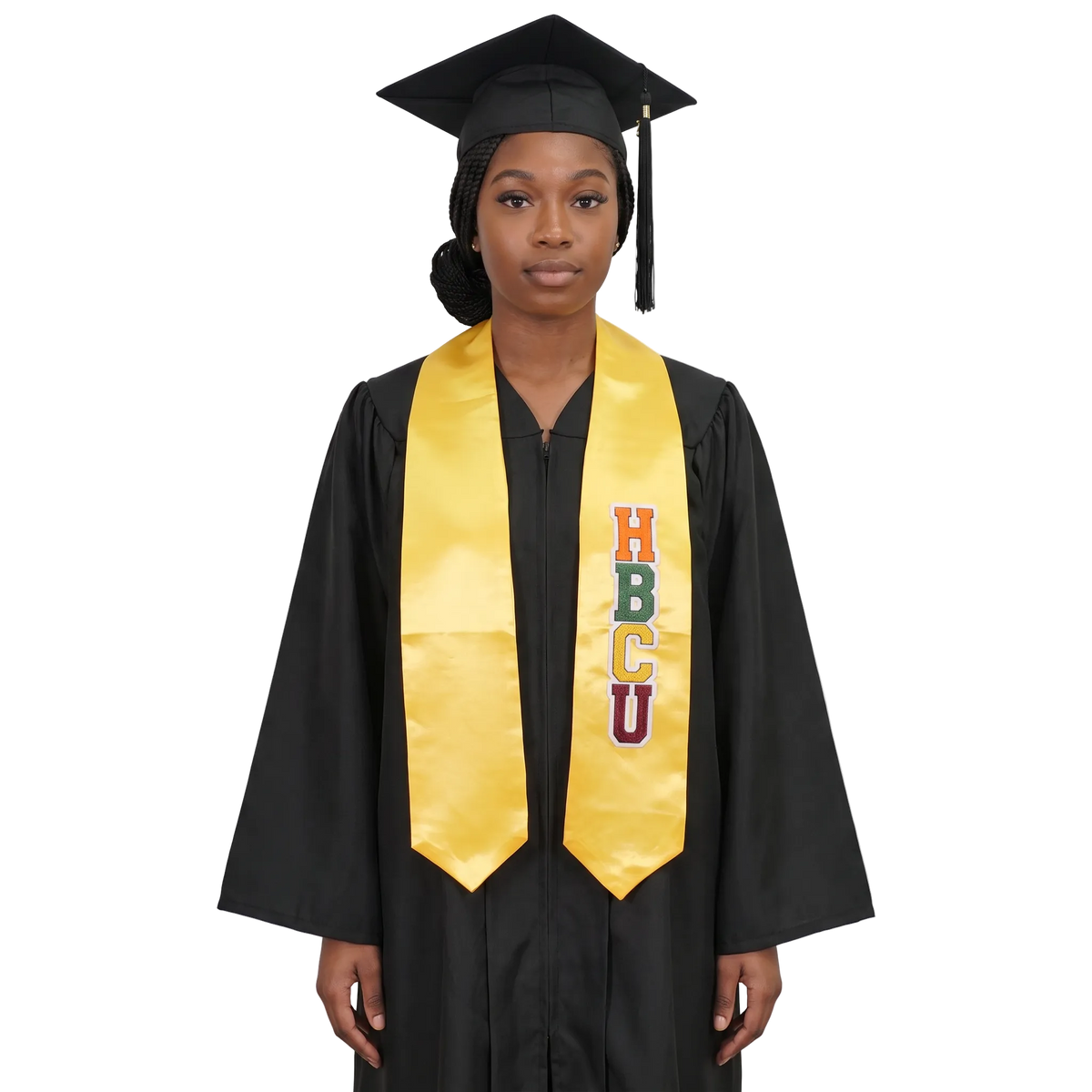 Graduate in a black cap and gown wearing a gold HBCU graduation stole with vertically stacked multicolored HBCU lettering on one side and pointed ends.
