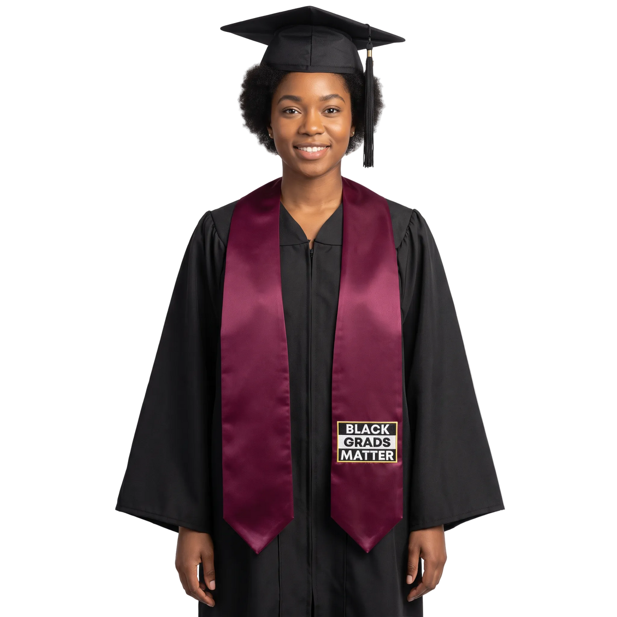 Maroon graduation stole with “BLACK GRADS MATTER” lettering in a black and white rectangular design outlined in gold on one side and pointed ends.
