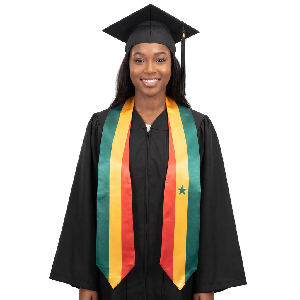 Graduate in a black cap and gown wearing a Senegal flag graduation stole with green, yellow, and red vertical stripes, a green star on one side, and pointed ends.
