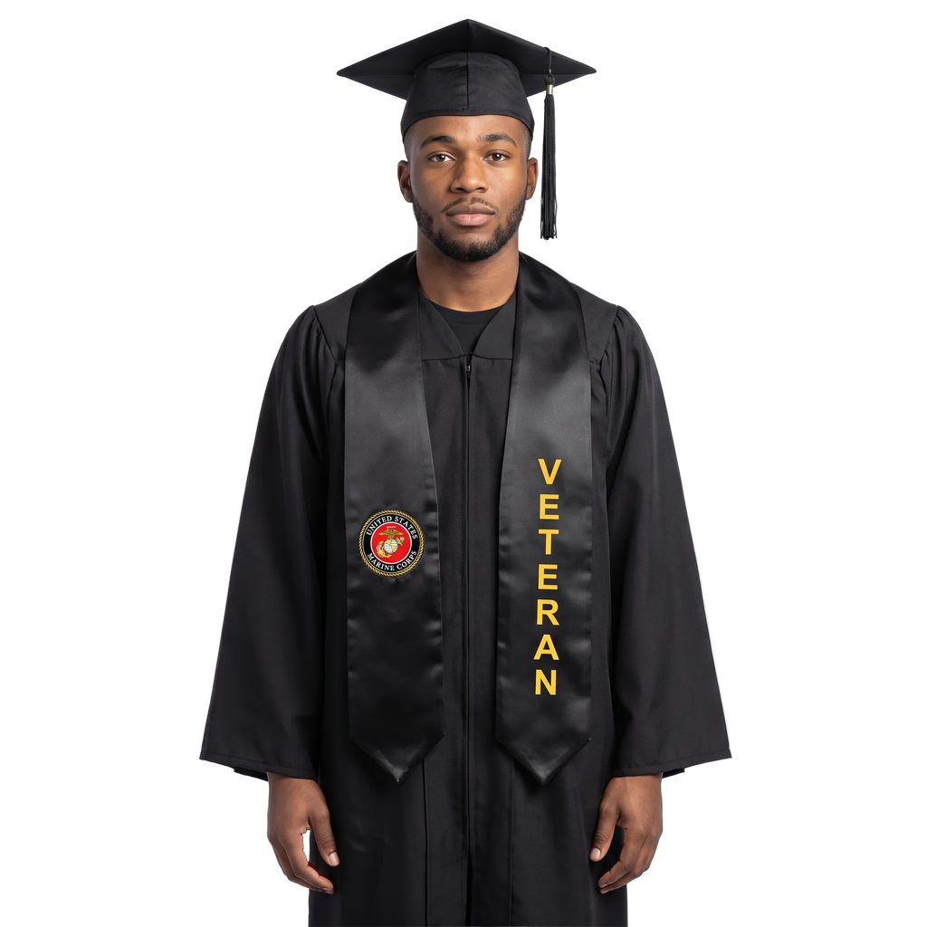 Graduate in a navy blue cap and gown wearing a black U.S. Marine Corps veteran graduation stole with a Marine Corps emblem on one side and vertical gold “VETERAN” lettering on the other.
