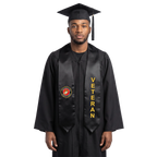Graduate in a navy blue cap and gown wearing a black U.S. Marine Corps veteran graduation stole with a Marine Corps emblem on one side and vertical gold “VETERAN” lettering on the other.
